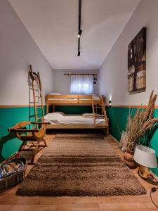 a bedroom with a bed and a chair and a rug at The Bearded Dad Hostel in Tirana