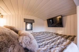 a dog laying on a bed in a room at Bo Peep Shepherds Hut Thorpeness Air Manage Suffolk in Leiston