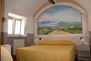 a bedroom with a large painting above a bed at B&B Antiche Mura in Puegnano del Garda
