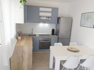 a kitchen with a white table and a white table and chairs at Seline Summer Home in Seline