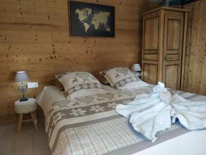 een slaapkamer met een bed in een blokhut bij Maison d'hôtes des Bassins d'Oche in Saint-Paul-en-Chablais