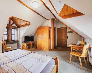 a bedroom with a bed and a desk and a table at Fremden- und Monteurzimmer "Zum Ochsen" in Flieden