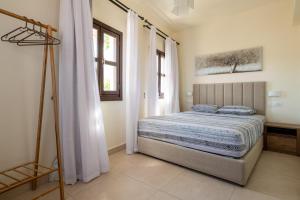 a bedroom with a bed in a room at To Rodi Apartments in Rhodes Town