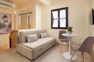 a living room with a couch and a table at To Rodi Apartments in Rhodes Town