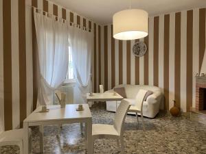 a living room with a couch and a table and chairs at House Villa Anna in Polignano a Mare