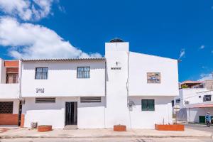a white building with a blue sky in the background at Hotel Casa Guajira Real in Ríohacha
