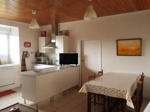 a kitchen and dining room with a table and a table and a kitchen at GÎTE DU BOUYSSOU in Carsac-Aillac