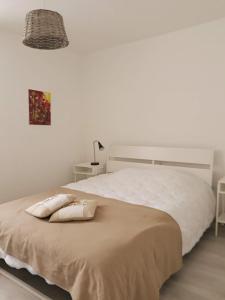 a bedroom with a bed with two pillows on it at GÎTE DU BOUYSSOU in Carsac-Aillac