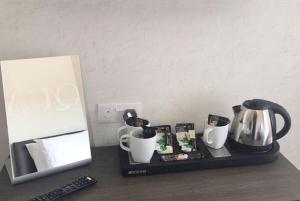 a counter with a coffee maker and cups on it at The Ships Quarters in Eyemouth