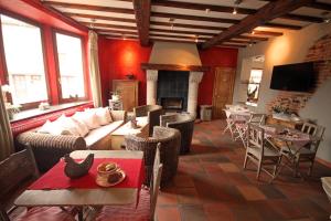 a living room with a couch and a table and chairs at Comme à la Ferme in Durbuy