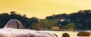 a view of a body of water with rocks at Pousada Casa do Oscar in Governador Celso Ramos