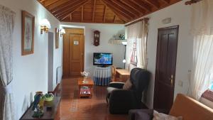 un soggiorno con divano e TV di Climatized Pool Free Wifi Casa Rural Las Pareditas a Tijarafe