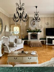 a living room with a chandelier and a fireplace at Ach to tu in Malbork
