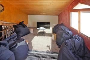 a living room with two couches and a table at Scenic Village Home with Lake Panorama in Sainte-Croix-de-Verdon