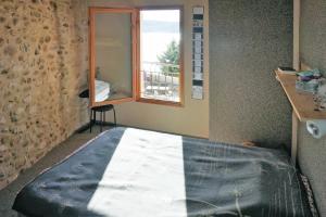 a bed in a room with a window at holiday home, Sainte-Croix-du-Verdon in Sainte-Croix-de-Verdon