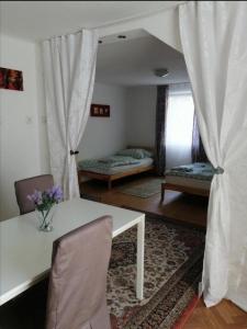 a living room with a table and two beds at ApartGraz in Graz
