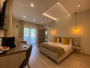 a bedroom with a bed and a couch and a table at Amethyst in Sovata