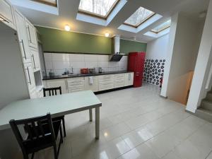 a kitchen with a table and a red refrigerator at city-pillow rooms in Luxembourg