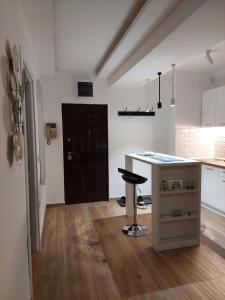 a kitchen with a counter and a stool in a room at Room 23 in Belgrade
