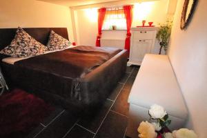 a bedroom with a large bed and a window at Holiday Home Storkow - DBS05105-F in Storkow