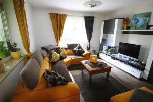 a living room with a couch and a tv at Holiday Home Storkow - DBS05105-F in Storkow