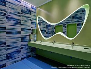 a bathroom with two sinks and a mirror at prizeotel Hamburg-City in Hamburg