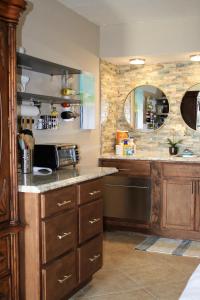 a kitchen with a counter with a sink and a dishwasher at Bay Mariner - Gorgeous Water Front Condo! in Sarasota