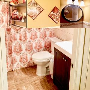 a bathroom with a toilet and a sink and a mirror at Charity's Haven II in Waldorf