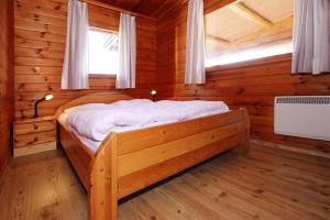 a bedroom with a bed in a log cabin at Blockhouse, Hasselfelde in Hasselfelde