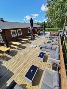a deck with lounge chairs and umbrellas on it at Surnadal Camping Brekkøya in Surnadal