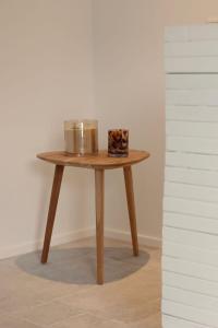 a small wooden table with a container on it at Casa Honey in Liège