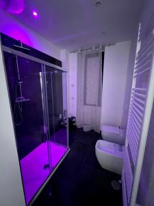 a bathroom with a glass shower and a toilet at Dimora al Centro in Cosenza