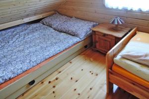 a small bedroom with a bed and a night stand at Holiday resort, Wiselka in Wisełka