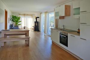 a kitchen with white cabinets and a wooden floor at 4 star holiday home in Gaal im Murtal in Pirkach