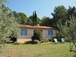 a house with two chairs in a yard at Cottage in Luberon near Apt Market in Apt +12 photos