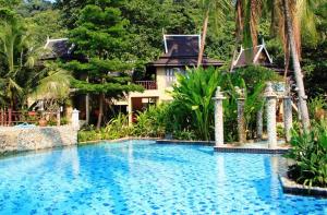 a swimming pool in front of a house at Bhumiyama Plus in Ko Chang