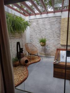 a room with a patio with a chair and a table at Pousada Santa Vila in Serra do Cipo