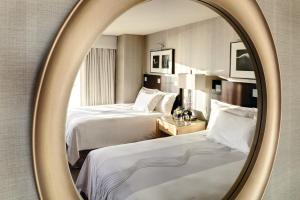 
a bedroom with a mirror and a bed at Borgata Hotel Casino & Spa in Atlantic City
