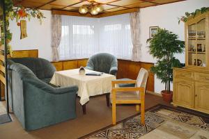 a dining room with a table and two chairs and a table and a table at House, Steinbach-Hallenberg in Altersbach