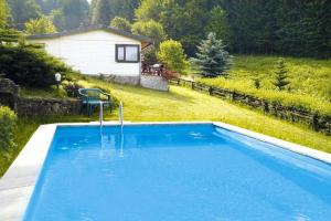 a swimming pool in a yard with a house at House, Steinbach-Hallenberg in Altersbach