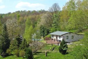 a house in the middle of a field with trees at House, Steinbach-Hallenberg in Altersbach