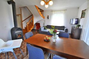 a living room with a table and a living room with a stove at holiday home, Wicie in Wicie