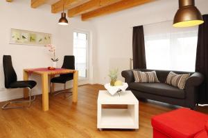 a living room with a couch and a table at Apartment in Lissendorf with a paid private sauna in Lissendorf