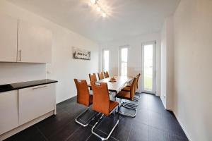 a kitchen and dining room with a table and chairs at Semi-detached houses, Strausberg in Strausberg