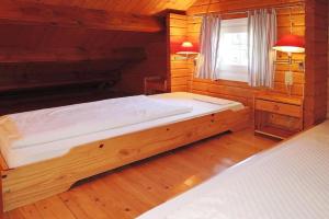 LissendorfにあるCottage, Lissendorfの木製の部屋に大型ベッドが備わるベッドルーム1室が備わります。