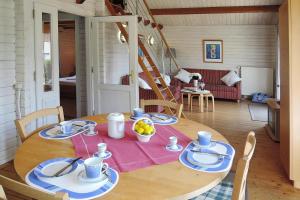 a wooden table with plates and bowls of fruit on it at Cottage, Lissendorf in Lissendorf