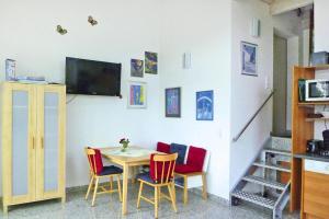 a dining room with a table and four chairs at Apartment, Zell im Wiesental in Zell im Wiesental