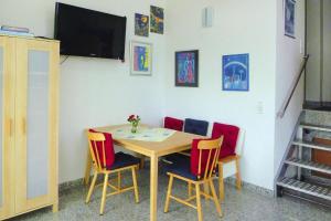 a table with chairs and a television in a room at Apartment, Zell im Wiesental in Zell im Wiesental