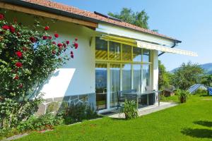 a house with large windows and a garden at Apartment, Zell im Wiesental in Zell im Wiesental