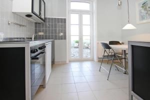 a kitchen with a sink and a table with chairs at Apartment, Zahrensdorf in Zahrensdorf